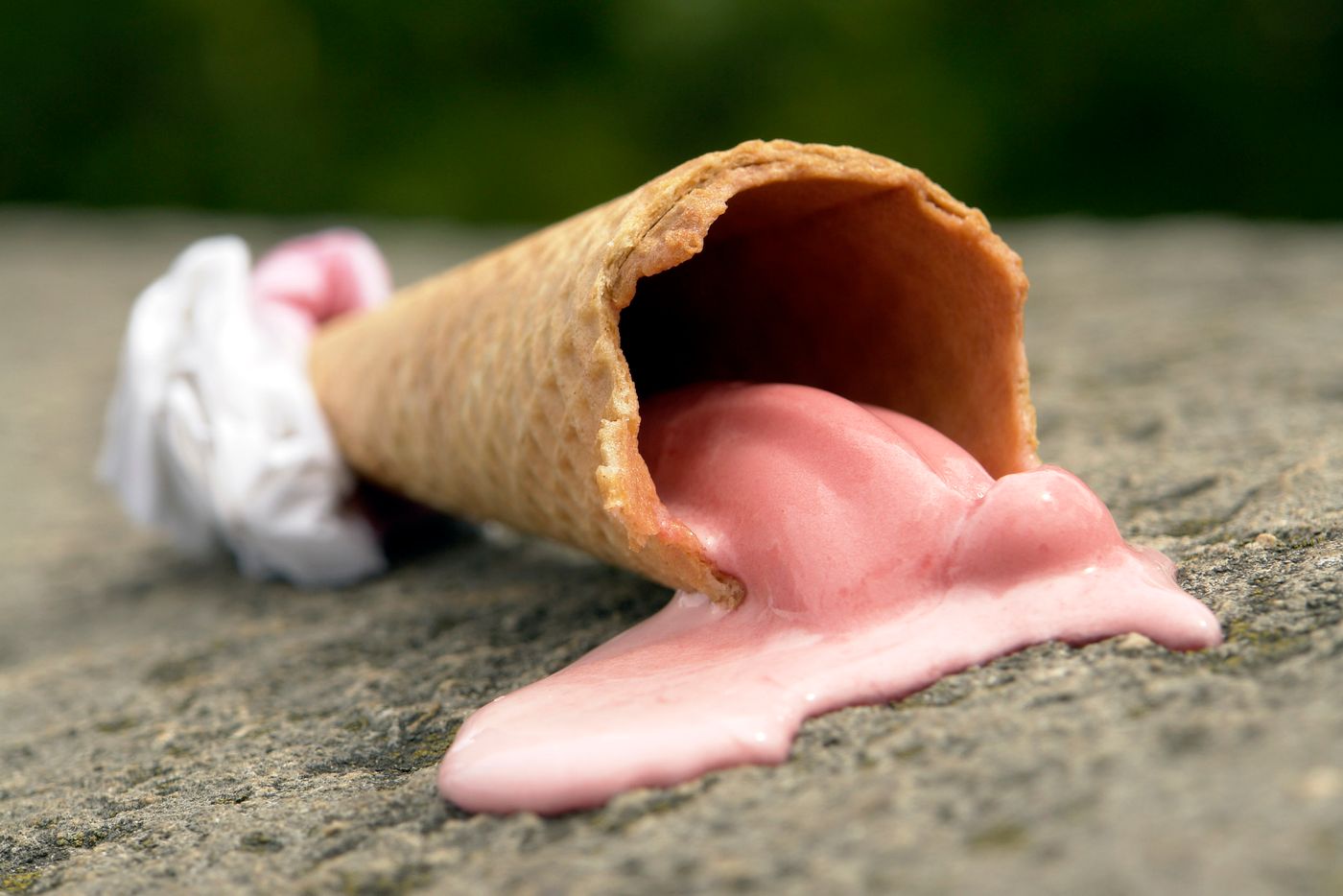 Melted ice cream dripping from a cone