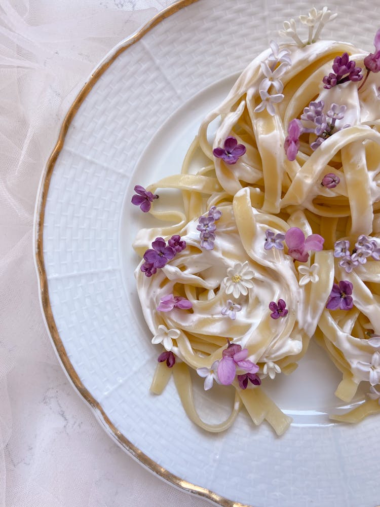 Pasta On White Dish Decorated With Flowers