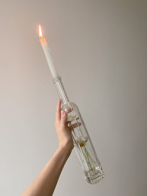 Free Womans Hand Holding Bottle with Candle Stick Stock Photo
