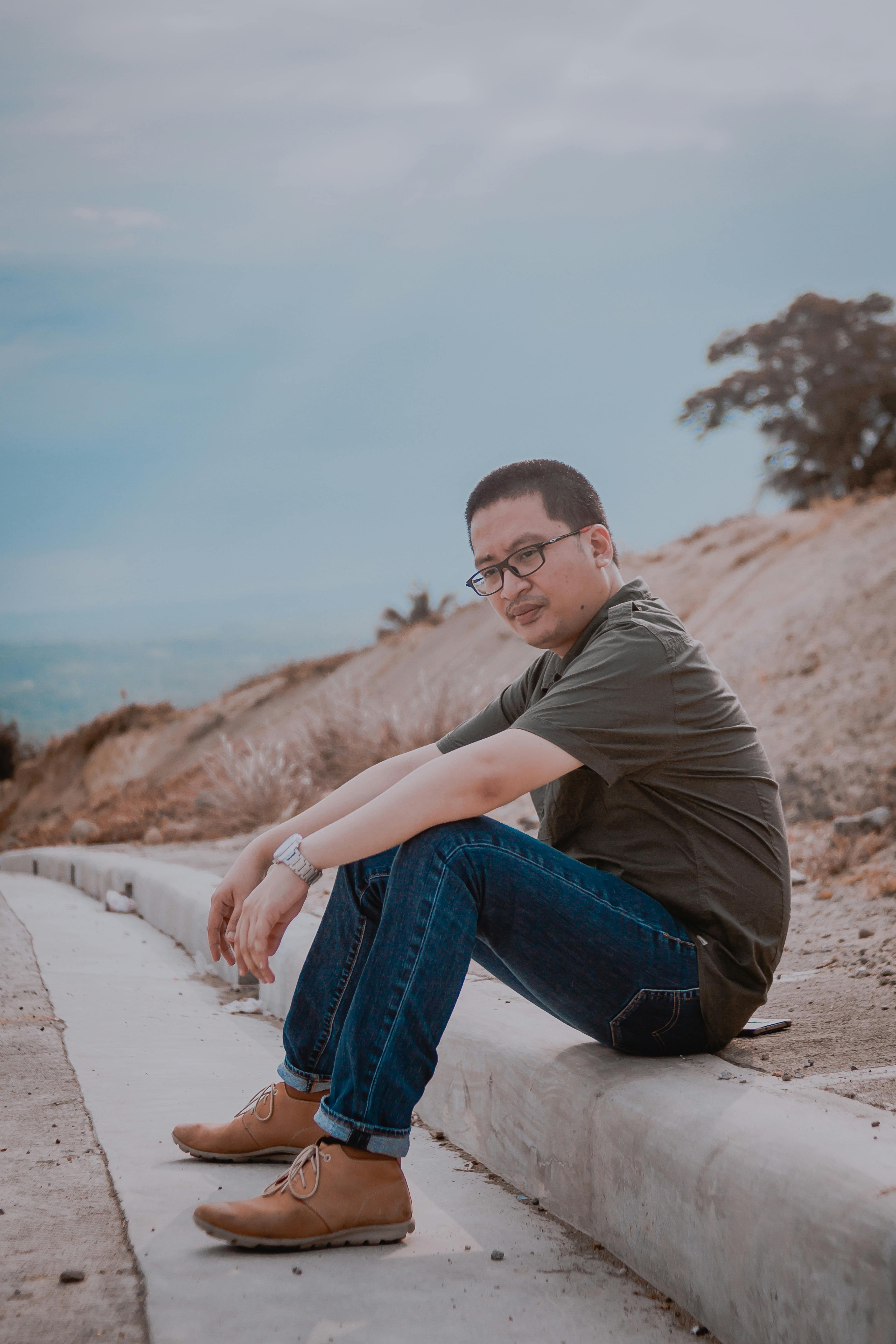 Man Sitting On Road Gutter · Free Stock Photo