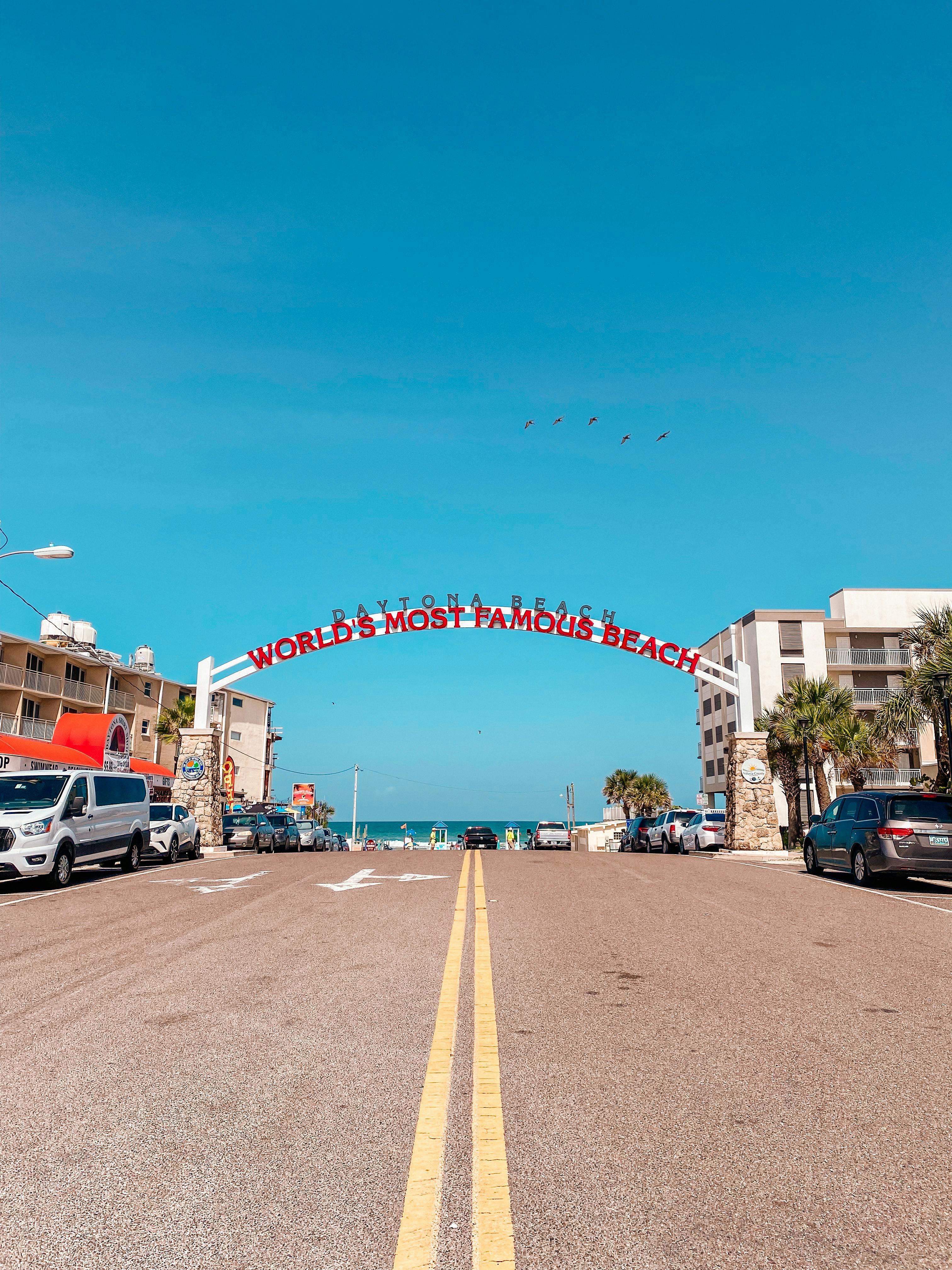 cars parked on roadside near beach