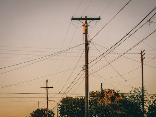 Brown Electric Post Under Gray Sky