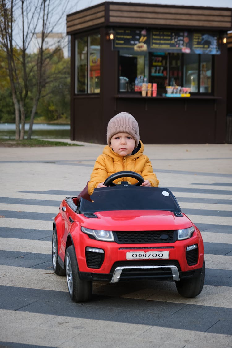 Child Driving Toy Car