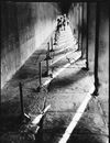 People Walking and Standing under Colonnade of Old Building