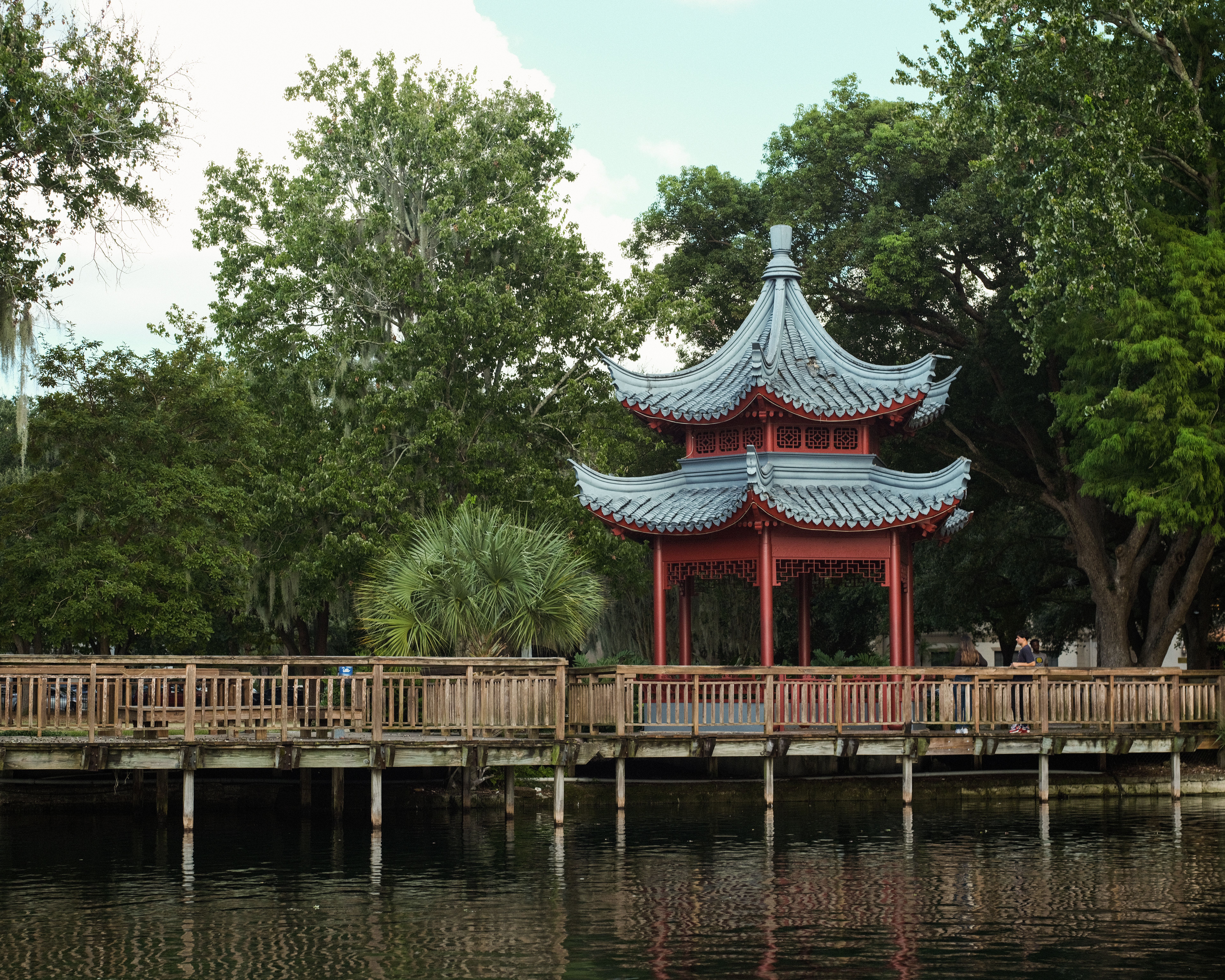 Beautiful pagoda surrounded by lush greenery at Lake Eola, a serene travel destination.