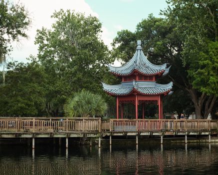 Beautiful pagoda surrounded by lush greenery at Lake Eola, a serene travel destination.