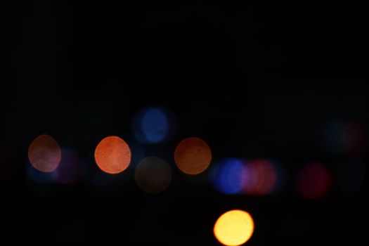 Blurred bokeh lights creating a vibrant scene in nighttime Hangzhou, China.