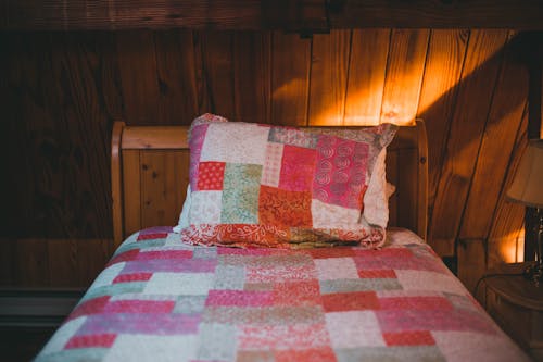 A Shot of a Bed in Wooden Interior 