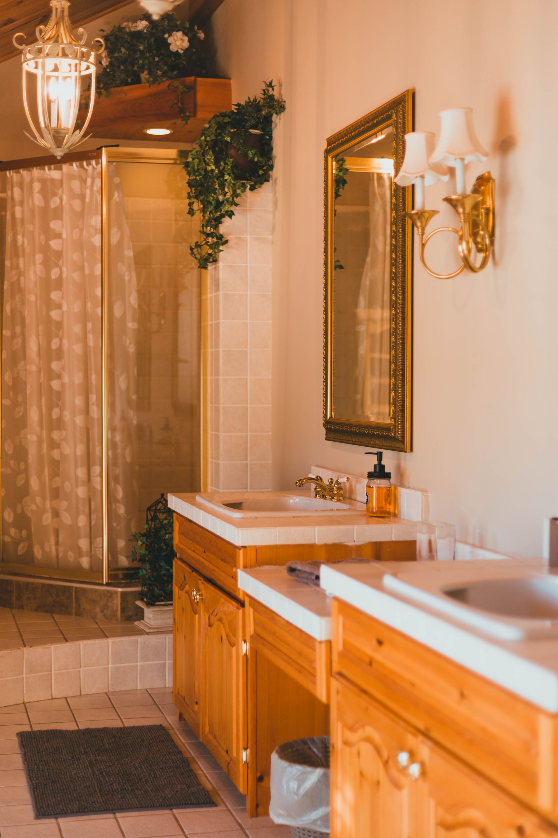 Warm-toned bathroom with wooden vanity, mirror and soft lighting