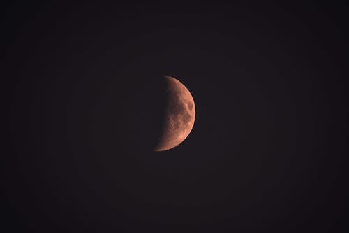 Photograph of a Half Moon During the Night