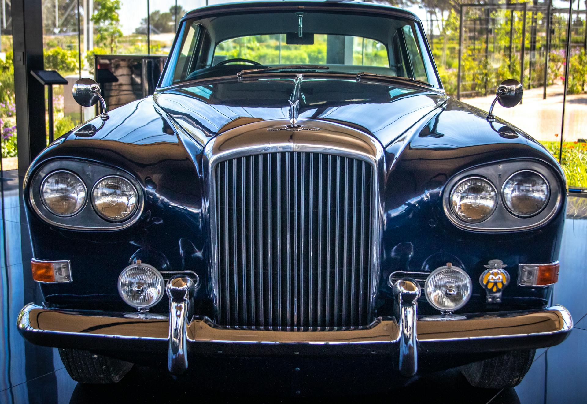 Front view of a classic vintage Bentley S3 car showcased in a museum.