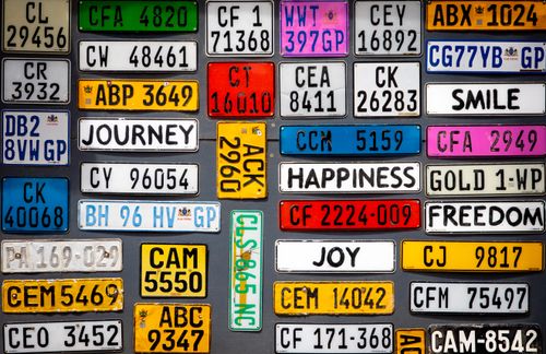 Free A vibrant display of assorted vintage license plates with inspirational words. Stock Photo