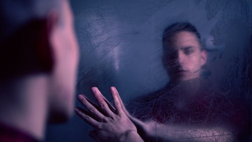 Free Man Looking in a Foggy Mirror  Stock Photo