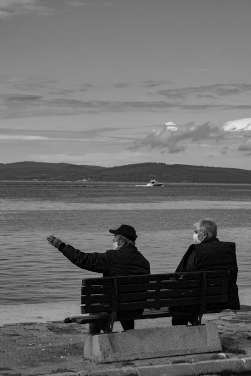Free Grayscale Photo of Elderly Men Sitting on Bench Stock Photo
