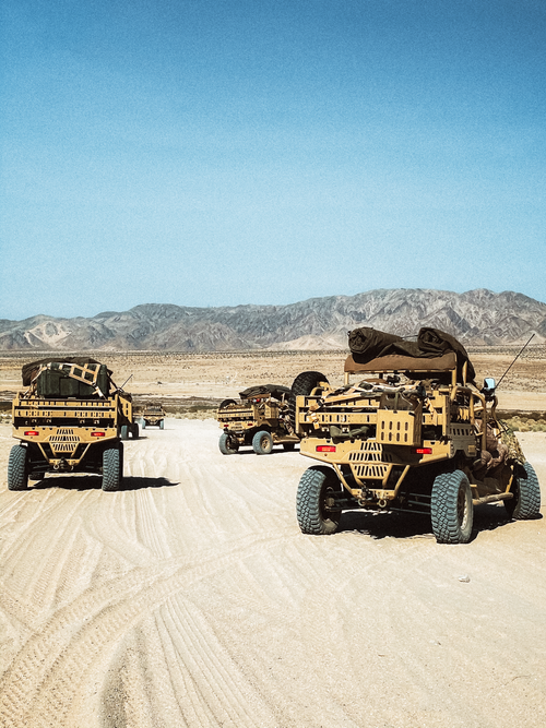 Free A group of military vehicles traversing a sandy desert landscape in California. Stock Photo