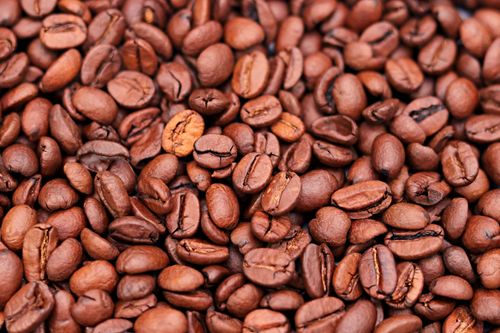 Free Detailed close-up of roasted brown coffee beans, ideal for brewing aromatic coffee. Stock Photo