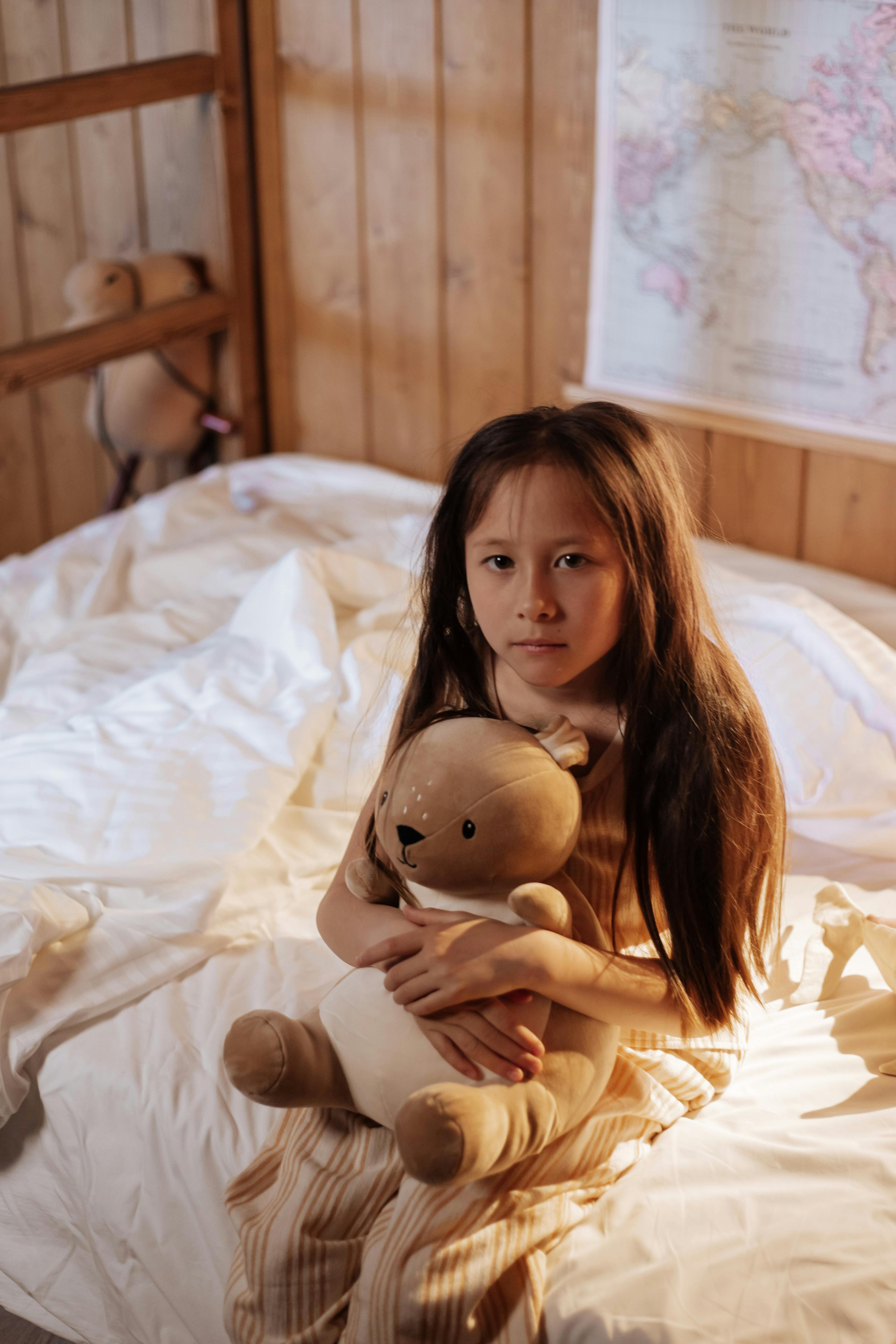 portrait of sick girl sitting on bed