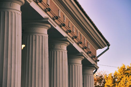 Beautiful neoclassical columns of a building captured during the day.