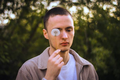 A Man holding Dandelion