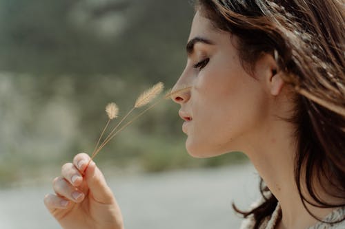 A Woman Holding Brown Grass