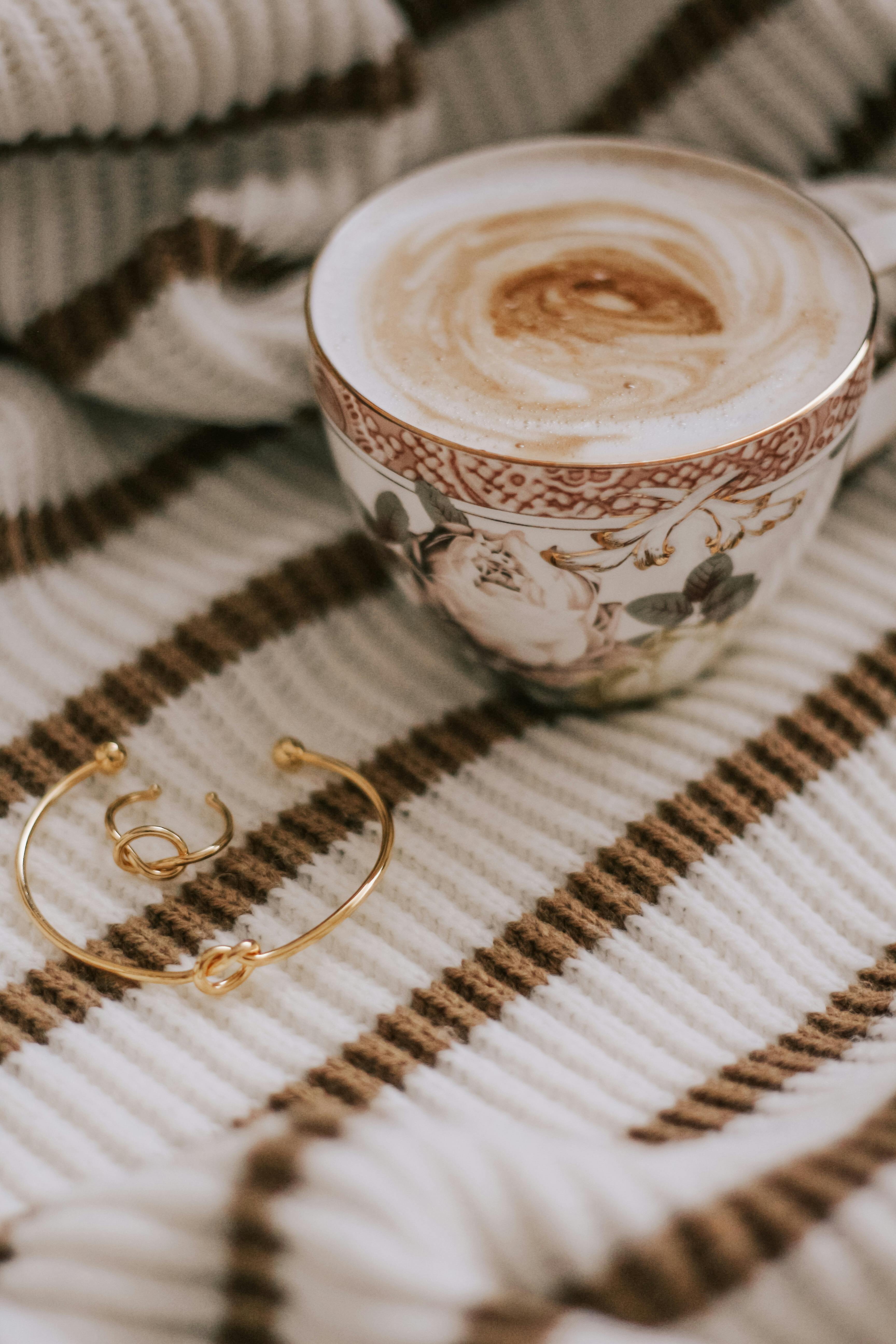 cup of coffee and gold jewellery