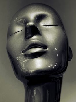 Close-up view of a sleek black mannequin head with a serene expression and elegant design.