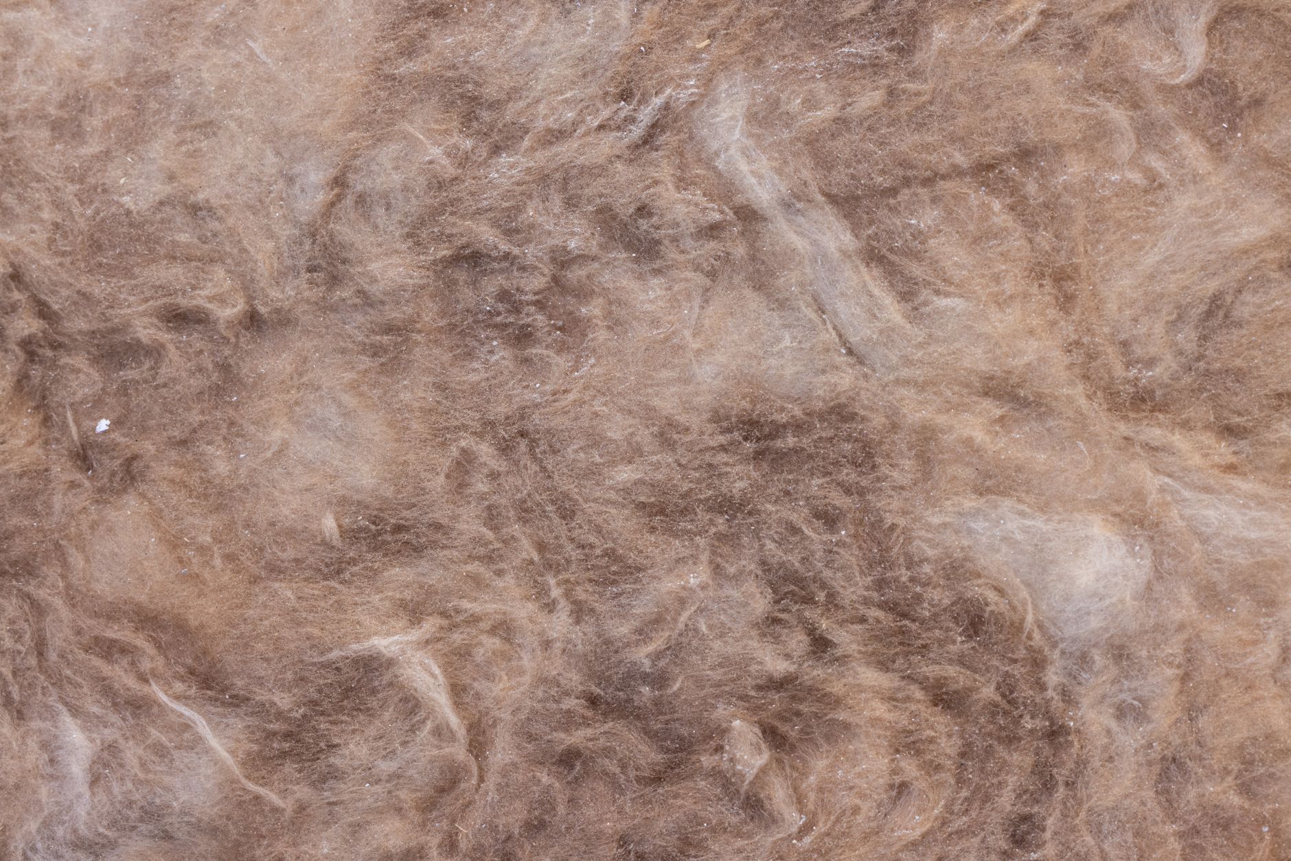 Detailed close-up view of brown wool texture, ideal for backgrounds.