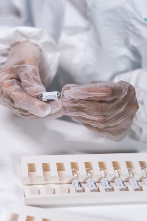 Hands Holding a Bottle With Vaccine 