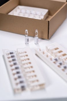 Close-up image of vials and packaging, suitable for medical and pharmaceutical themes.