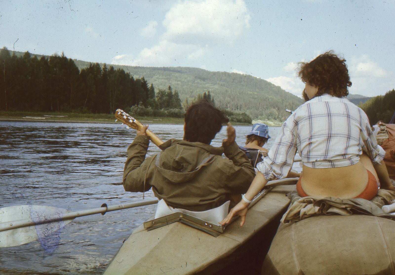Group of people kayaking on a calm river.