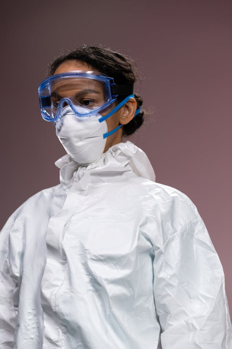 Woman Wearing Protective Uniform, Mask And Eyeglasses