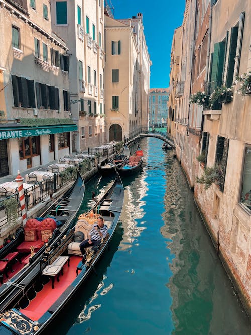 View of Gondolas in the Canal between Residential Buildings in Venice, Italy