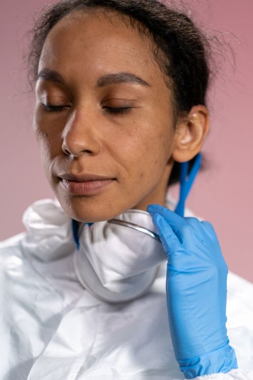 Free Healthcare worker wearing protective gear with eyes closed, symbolizing safety and focus. Stock Photo