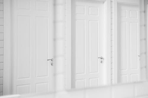 Free Three Equal White Doors in Mirror Stock Photo