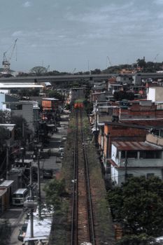 Aerial perspective of a vibrant urban neighborhood with railway tracks running through.
