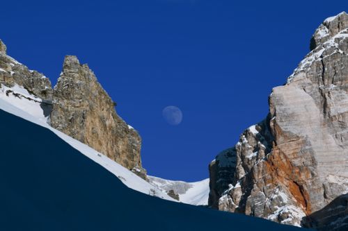 Free Breathtaking view of snowy peaks in the Dolomites, Italy, with a full moon. Stock Photo