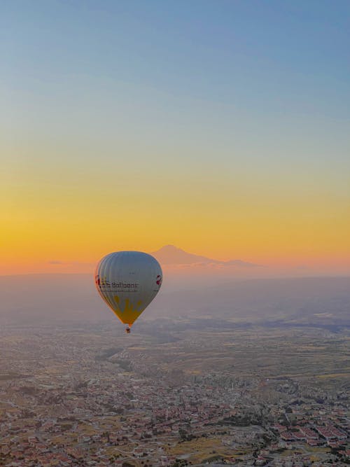 Hot Air Balloon Flying above Buildings
