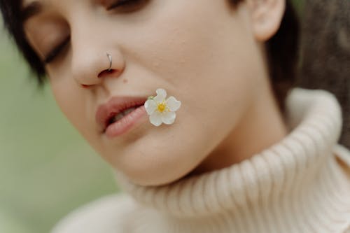 Woman with Flower on Her Lips
