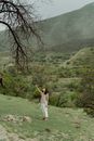 Woman on Green Grass Reaching Out to Tree Branches