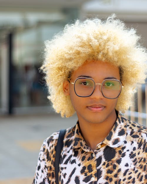 Free Portrait of a Boy with Blond Afro Hair Looking at the Camera Stock Photo