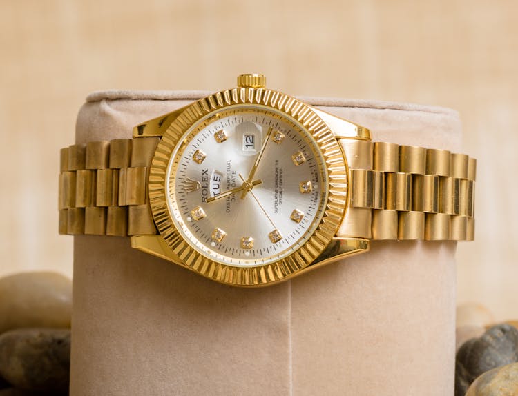 A Gold Rolex Watch With Diamonds