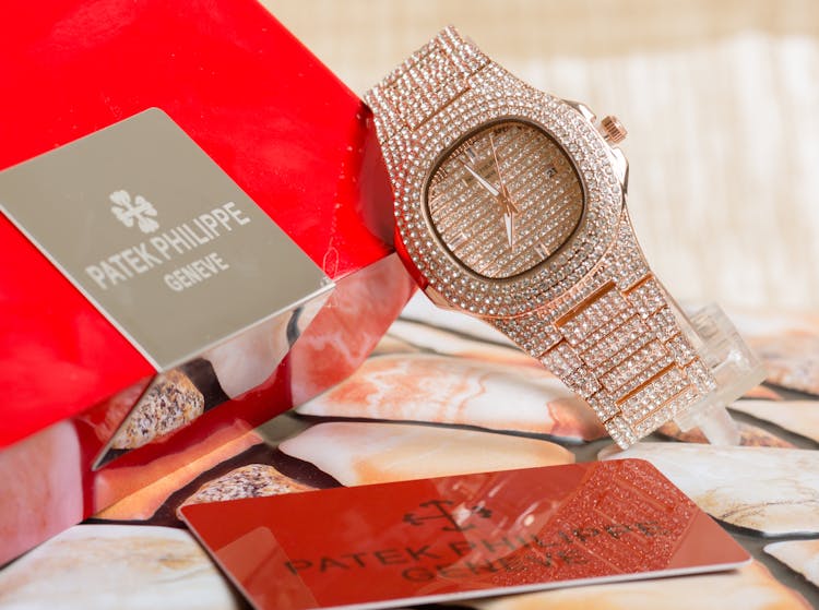 Photo Of A Wristwatch With Diamonds Near A Card