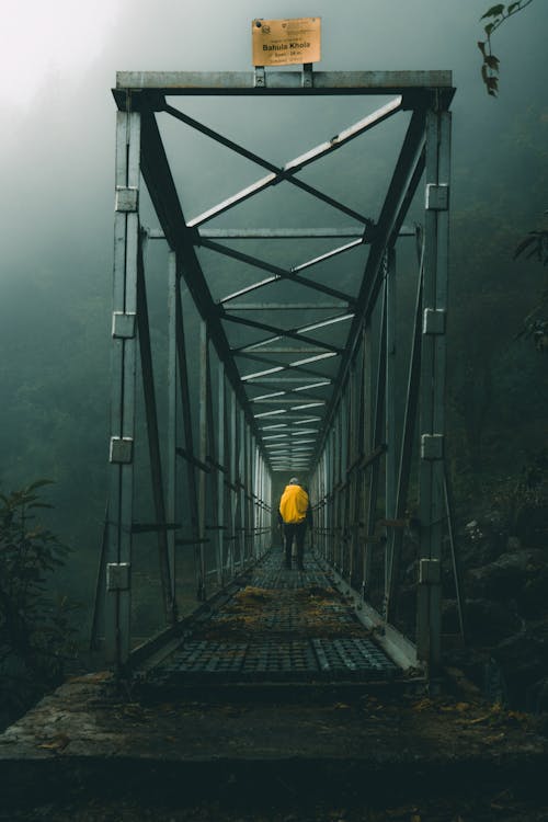 Back View of a Man in a Metal Bridge