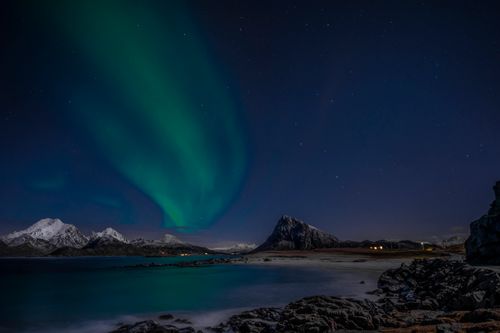Free Stunning aurora borealis over snow-capped mountains and night sky in Nordland, Norway. Stock Photo