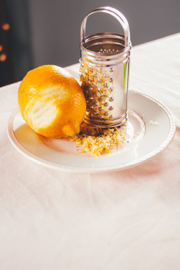 Grated Lemon On Plate With Grater