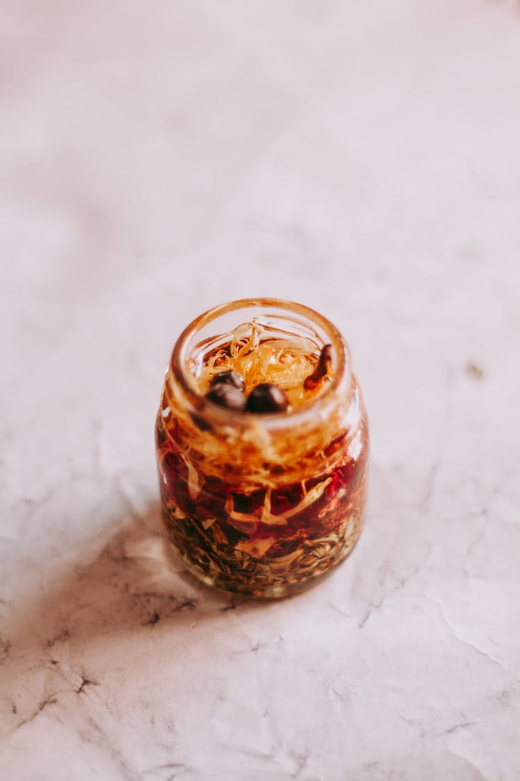 Small Glass Jar Of Medicinal Herbs