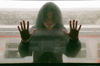 Teenage Girl in Black Hooded Blouse Looking Through Train Window