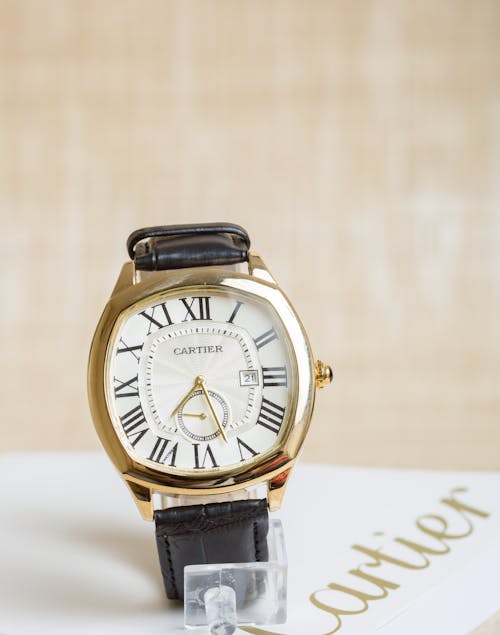 A Gold and White Analog Watch with Leather Strap