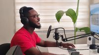 Broadcaster at a mixing desk — photo by Emmanuel Jason Eliphalet on Pexels