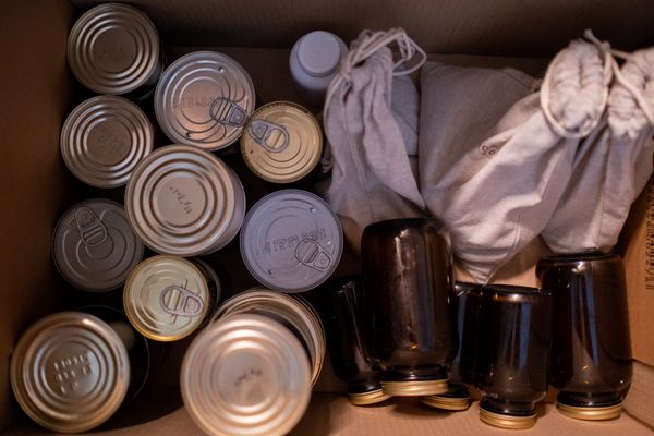 A box packed with canned goods and jars for storage
